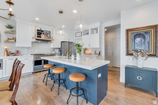 305 E 330 N, Vineyard, UT 84059 - kitchen featuring stainless steel appliances, open shelves, a breakfast bar area, light countertops, and backsplash