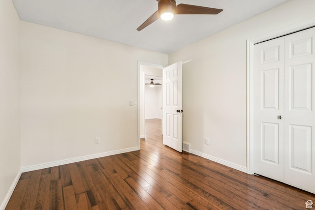 unfurnished bedroom featuring wood-type flooring, baseboards, a closet, and a ceiling fan