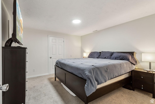bedroom featuring light colored carpet, baseboards, and recessed lighting