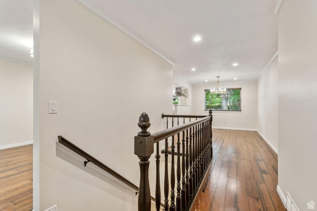 stairs with crown molding, hardwood / wood-style flooring, a chandelier, baseboards, and recessed lighting