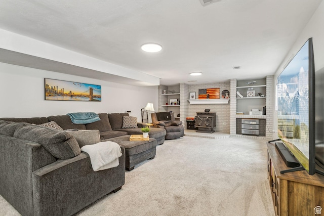 living area with carpet and a wood stove