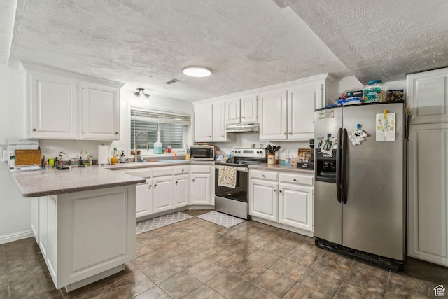 kitchen featuring appliances with stainless steel finishes, under cabinet range hood, a peninsula, white cabinets, and a textured ceiling