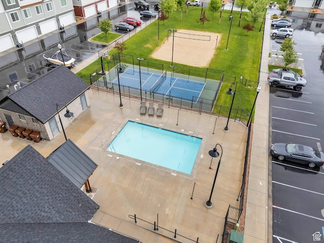 community pool featuring a tennis court