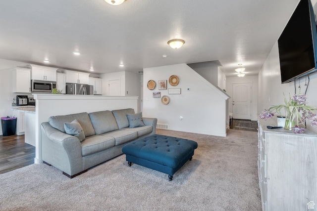 living room featuring light carpet and baseboards