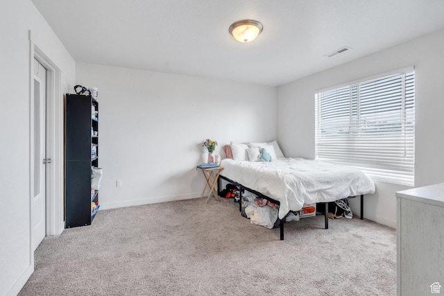 carpeted bedroom featuring baseboards