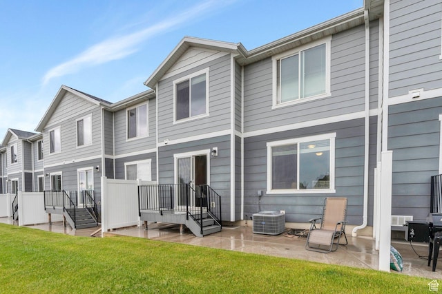 back of property featuring a patio, central air condition unit, and a yard