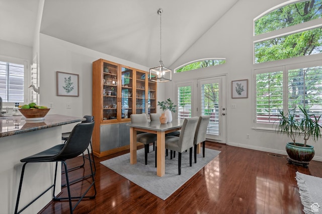 3678 S Vineyard Ct, Millcreek, UT 84106 - dining area with dark wood-style flooring, baseboards, and high vaulted ceiling