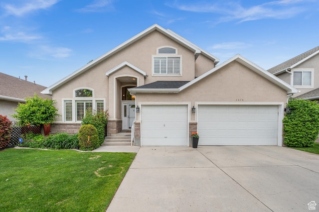 3678 S Vineyard Ct, Millcreek, UT 84106 - view of front of house with driveway, stucco siding, a front yard, and brick siding