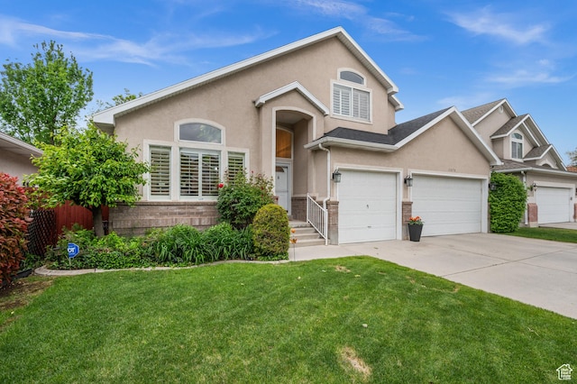 3678 S Vineyard Ct, Millcreek, UT 84106 - view of front facade featuring driveway, stucco siding, and an attached garage