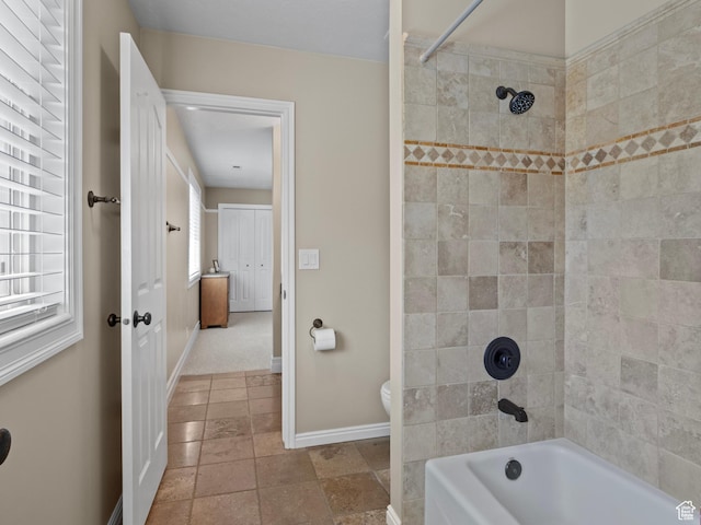 full bathroom with baseboards, bathing tub / shower combination, and toilet
