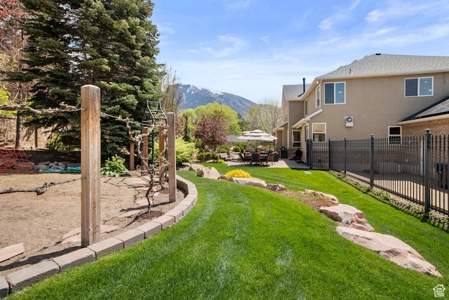 view of yard featuring a patio area and a mountain view
