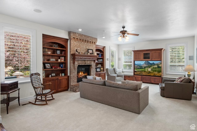 living room featuring a fireplace, a ceiling fan, light carpet, and baseboards