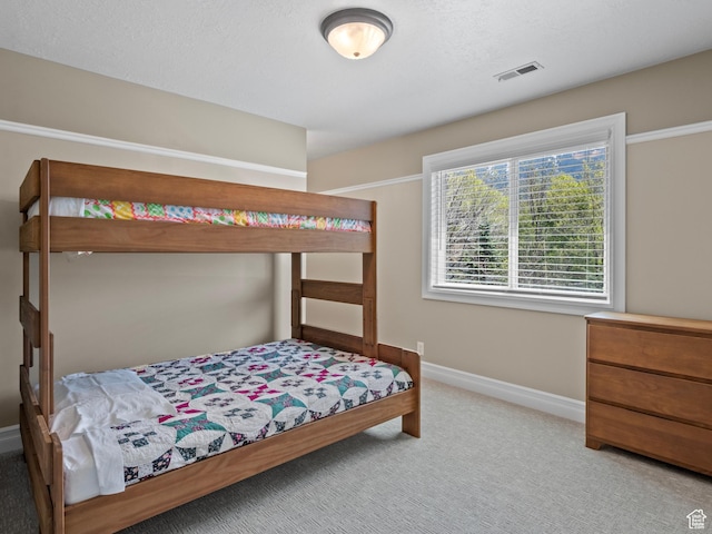 carpeted bedroom featuring baseboards