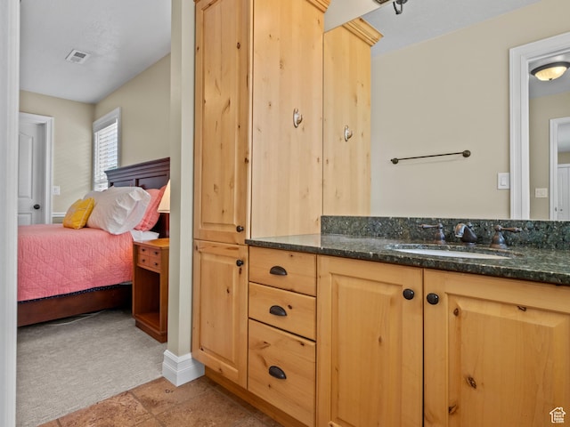 bathroom with vanity and connected bathroom