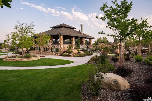 view of home's community with a lawn and a gazebo