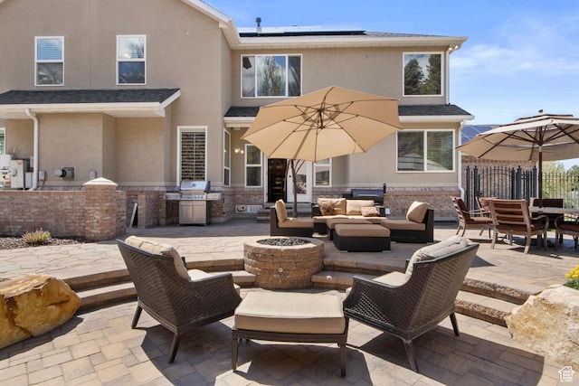 view of patio / terrace with an outdoor living space with a fire pit, area for grilling, fence, and outdoor dining area
