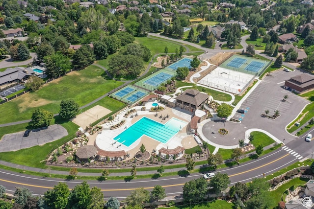 aerial view of property and surrounding area featuring a pool