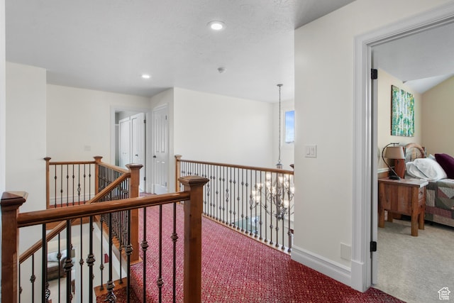 hallway featuring an upstairs landing, carpet floors, recessed lighting, and baseboards