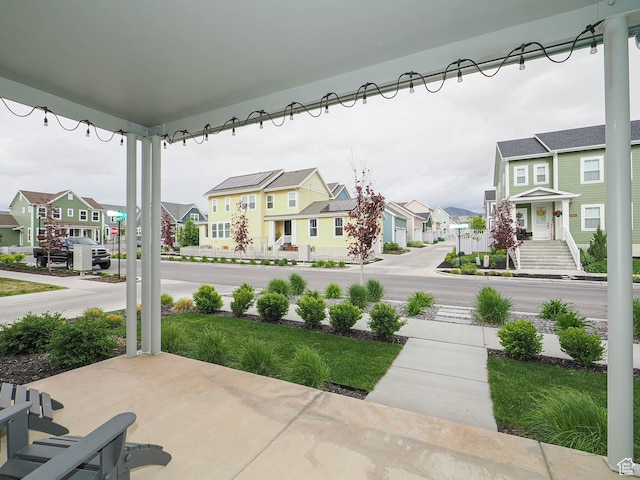 view of patio / terrace with a residential view and a porch