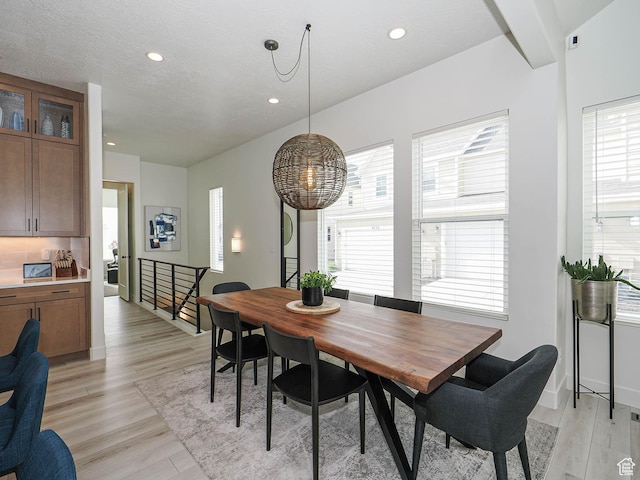 dining area with light wood-style floors, recessed lighting, and baseboards