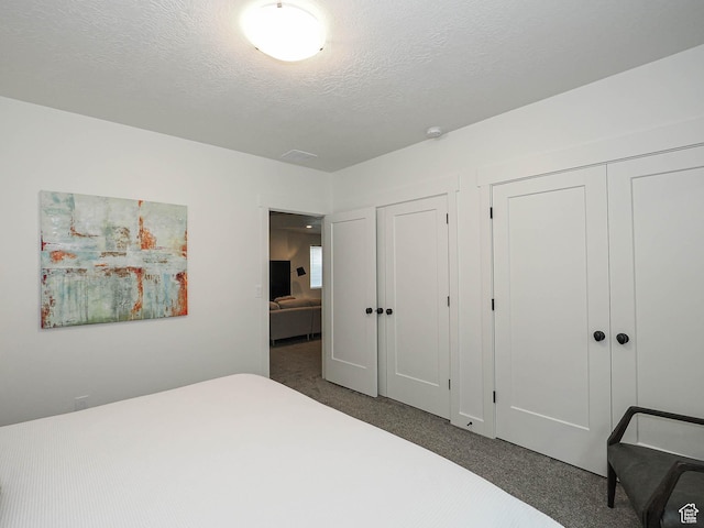 unfurnished bedroom with carpet and a textured ceiling