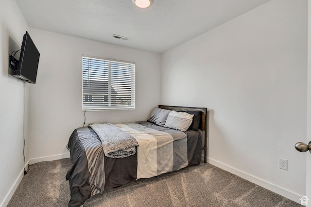 carpeted bedroom featuring baseboards