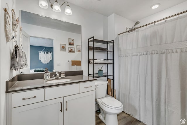 full bathroom with toilet, vanity, wood finished floors, and a shower with curtain