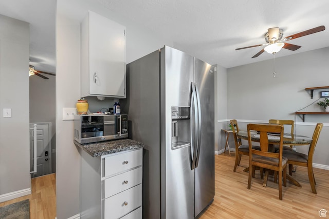 7963 S 2800 W, West Jordan, UT 84088 - kitchen with ceiling fan, stainless steel appliances, light wood-type flooring, white cabinetry, and baseboards