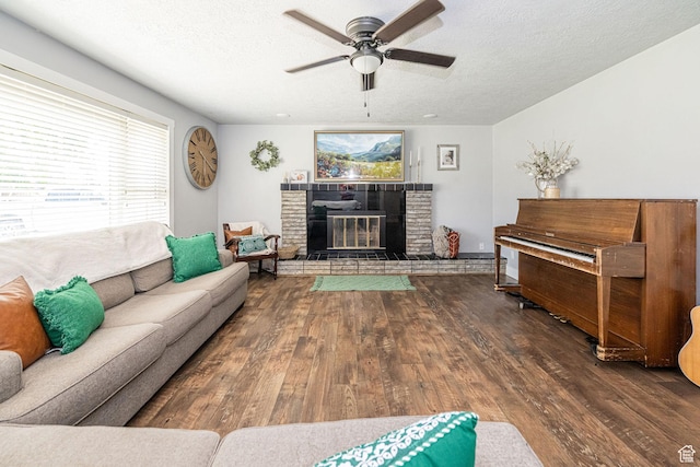 4302 W 2350 N, Plain City, UT 84404 - living area with a ceiling fan, wood finished floors, a textured ceiling, a brick fireplace, and healthy amount of natural light