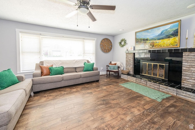 4302 W 2350 N, Plain City, UT 84404 - living area featuring a textured ceiling, ceiling fan, wood finished floors, and a brick fireplace