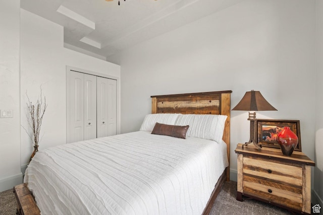 carpeted bedroom featuring a closet and baseboards