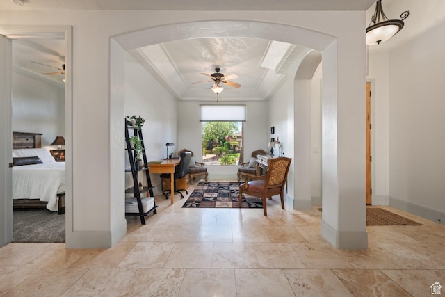 office space with a ceiling fan, arched walkways, baseboards, and ornamental molding