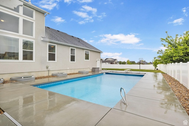 view of pool with a fenced backyard and a patio
