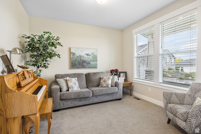 carpeted living room with baseboards