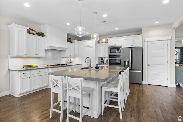 kitchen featuring appliances with stainless steel finishes, a sink, white cabinetry, and recessed lighting