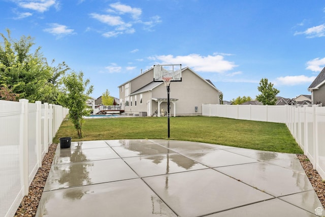 view of basketball court featuring basketball hoop and a residential view