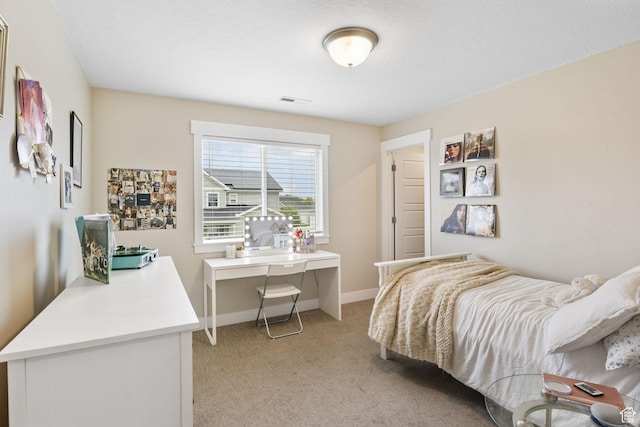 bedroom with light carpet and baseboards