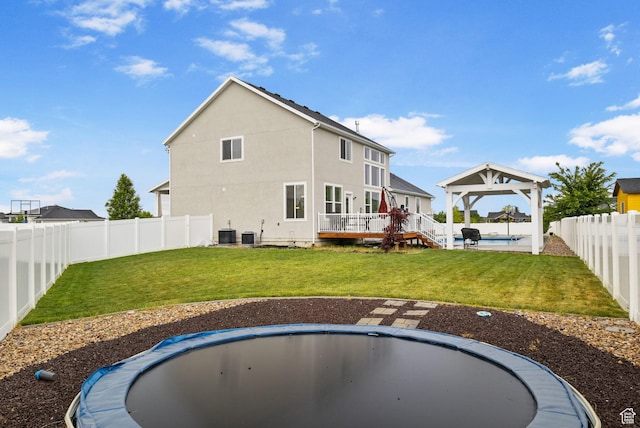 back of property with a gazebo, central AC, stucco siding, and a deck