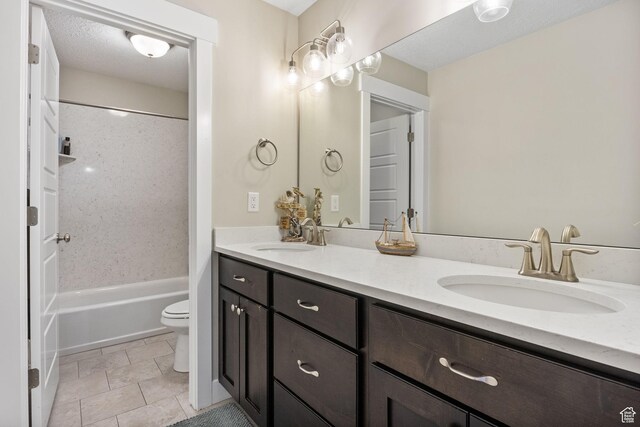 bathroom featuring double vanity, toilet, washtub / shower combination, and tile patterned floors