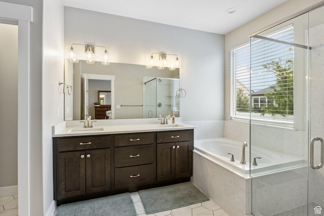 bathroom featuring a shower stall, tile patterned flooring, a garden tub, ensuite bath, and double vanity
