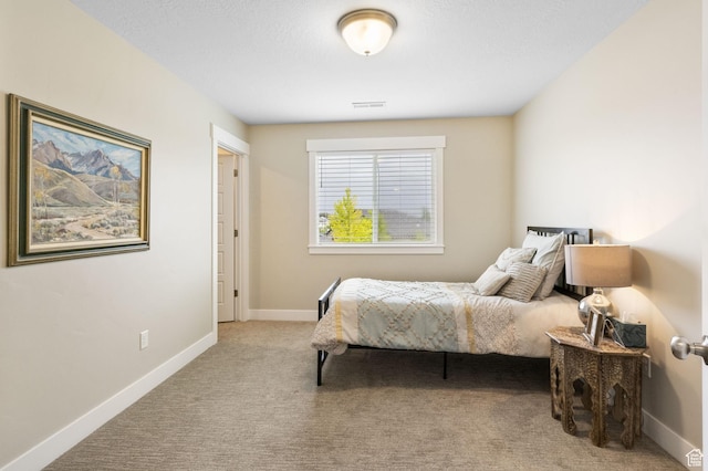 bedroom with carpet flooring and baseboards