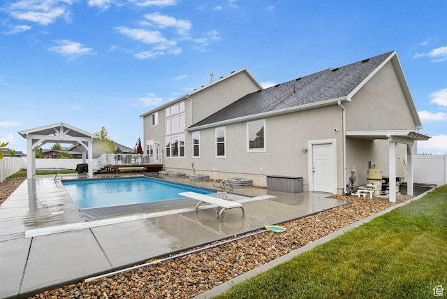 view of swimming pool featuring a fenced backyard, a gazebo, a deck, and a patio area