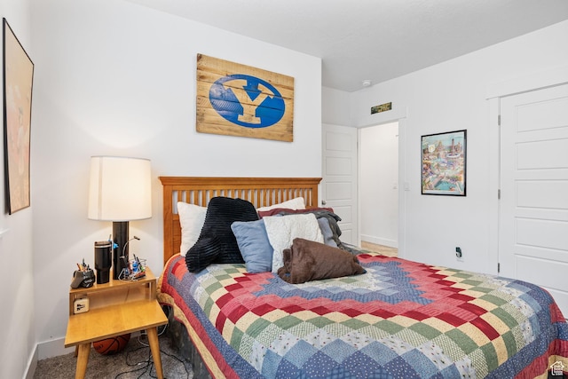 bedroom featuring carpet flooring and baseboards
