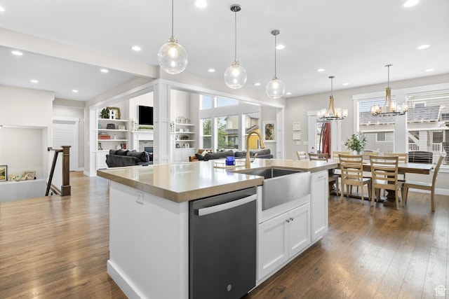 kitchen with dishwasher, a sink, dark wood-style floors, a kitchen island with sink, and white cabinetry
