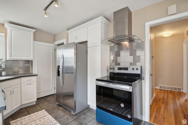 2484 S 800 E, Salt Lake City, UT 84106 - kitchen featuring stainless steel appliances, wall chimney exhaust hood, decorative backsplash, and white cabinets