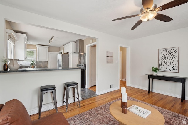 2484 S 800 E, Salt Lake City, UT 84106 - living area featuring light wood-style floors, ceiling fan, and baseboards