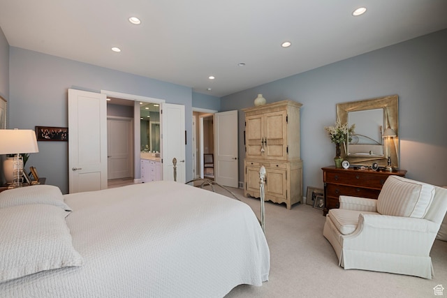 bedroom featuring recessed lighting, light carpet, and ensuite bathroom