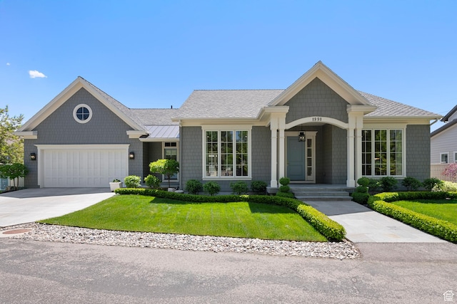 single story home with a front lawn, a standing seam roof, an attached garage, driveway, and metal roof
