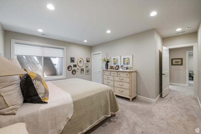 bedroom with light colored carpet, recessed lighting, and baseboards