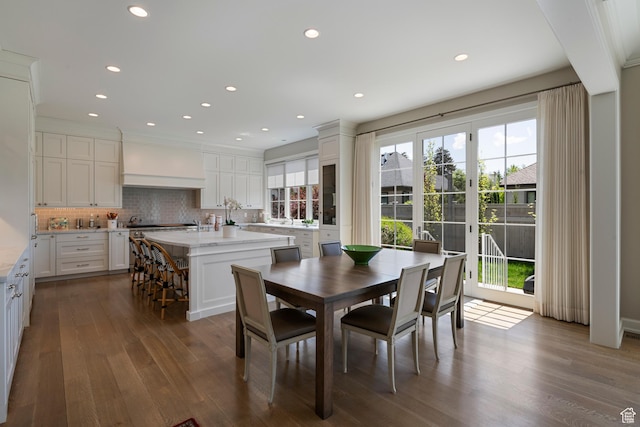 dining space with dark wood-type flooring and recessed lighting